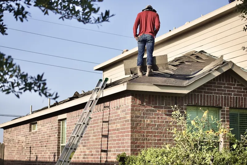 Professional roofer working on a residential roof in Ridgewood Junction